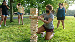 Emerging Leaders Student Scholars playing Jenga outside.